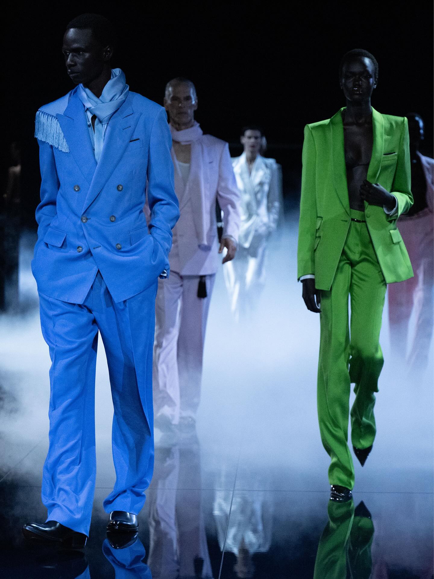 Models walk the runway in bold tailored suits, showcasing 2026 Fashion Trends with vibrant colors and modern silhouettes.