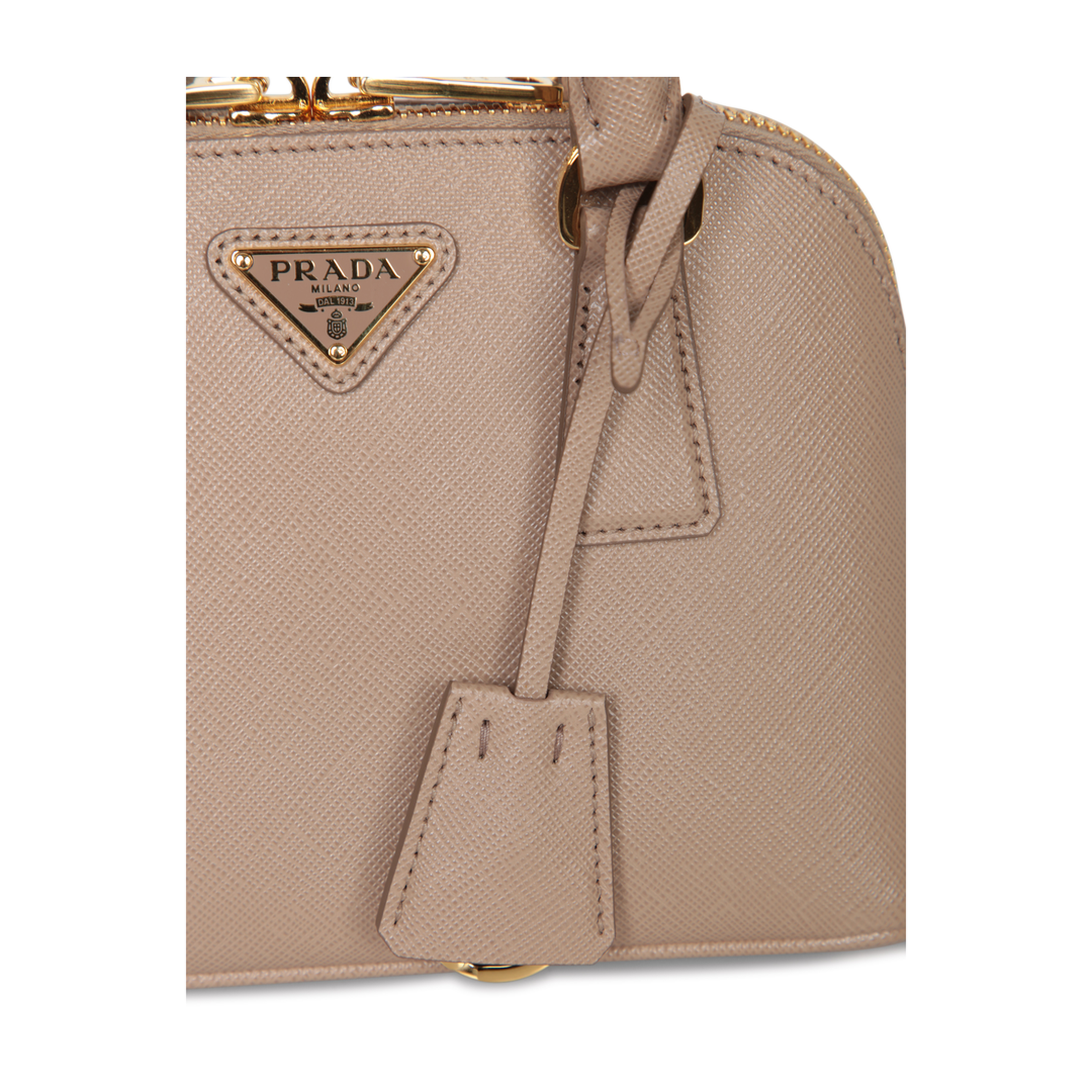 Crafted from Saffiano leather. Features top handles and an adjustable shoulder strap. Top zip closur