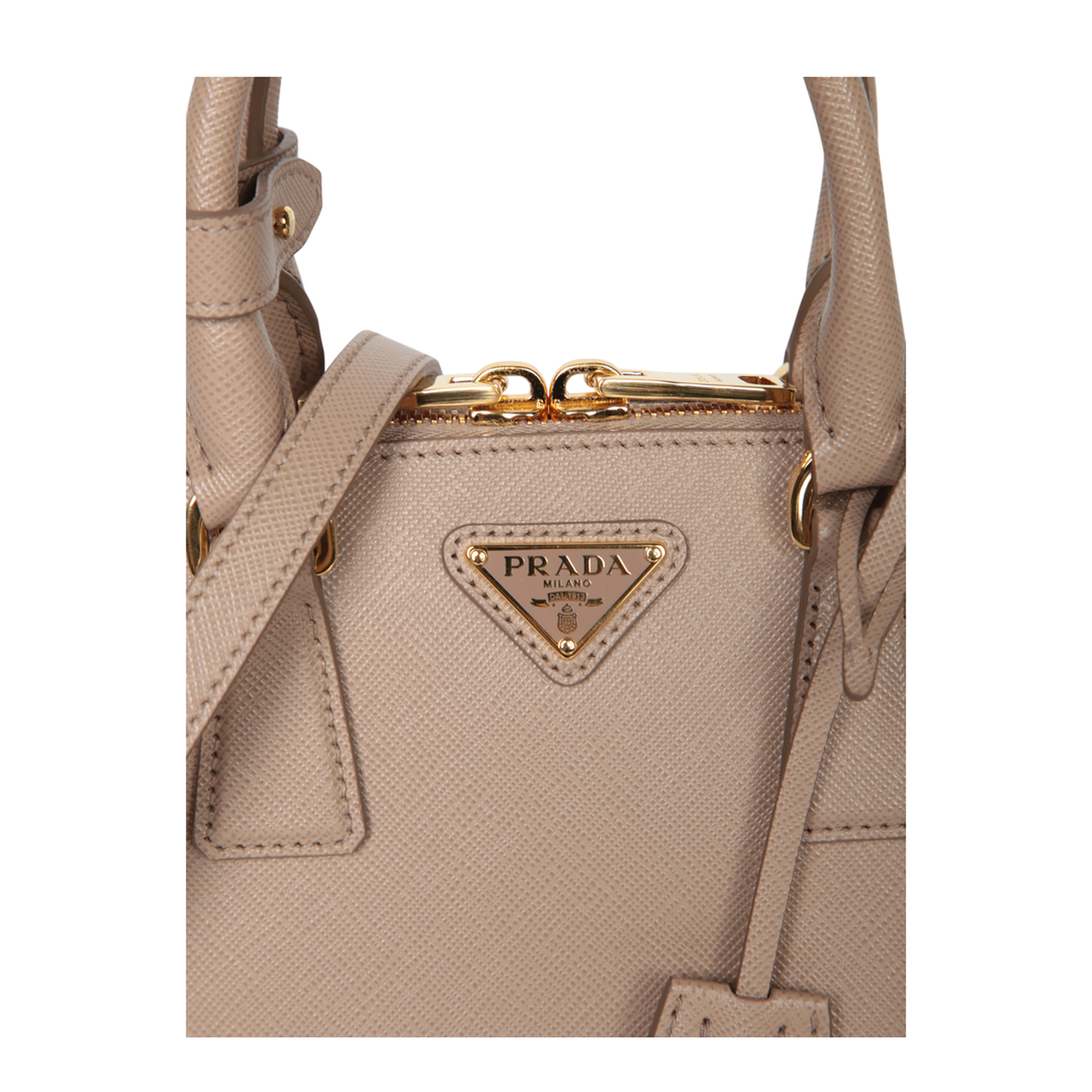Crafted from Saffiano leather. Features top handles and an adjustable shoulder strap. Top zip closur