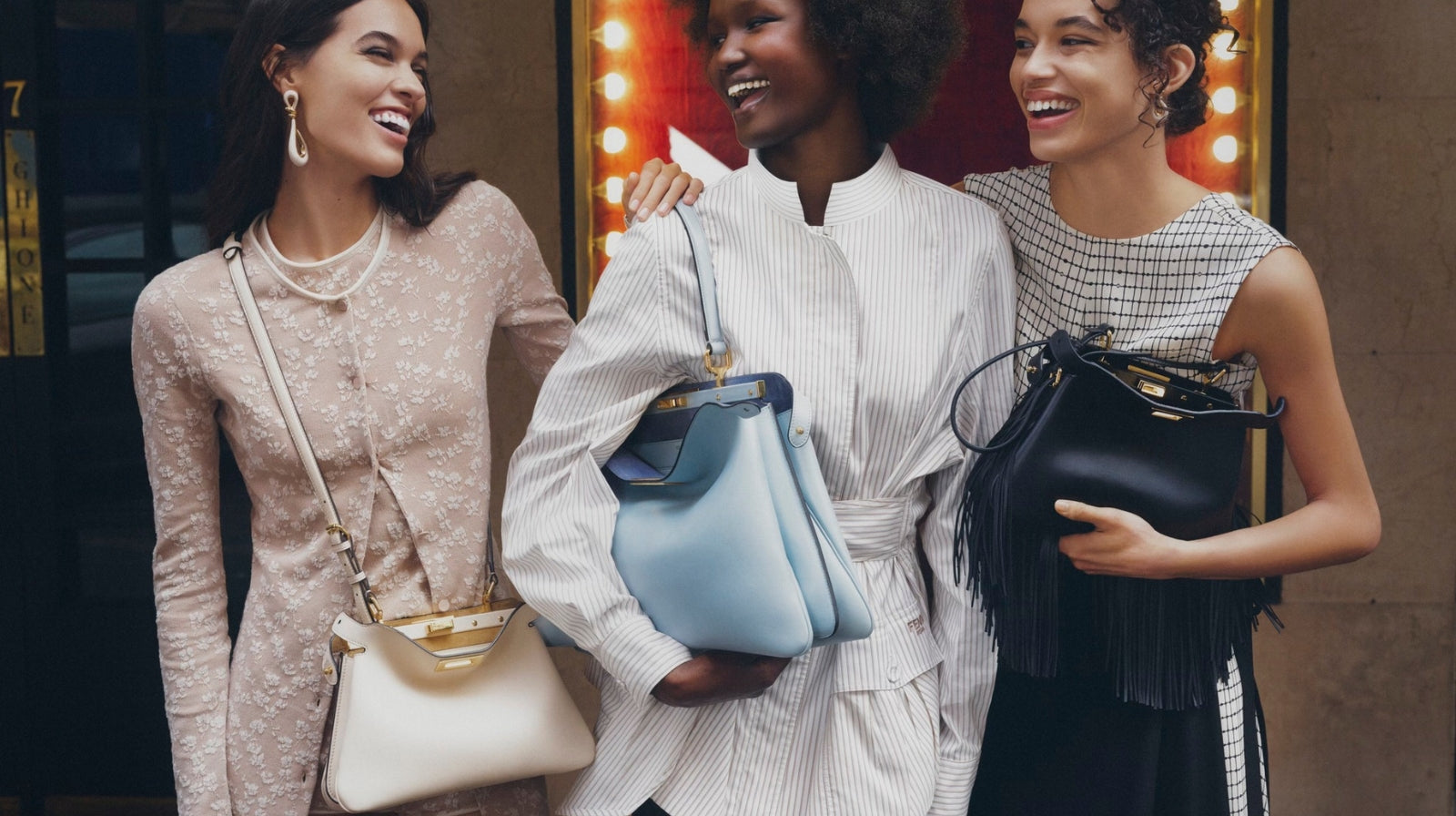 Three stylish women carrying designer handbags, capturing key looks from the 2025 Fashion Trends Recap.
