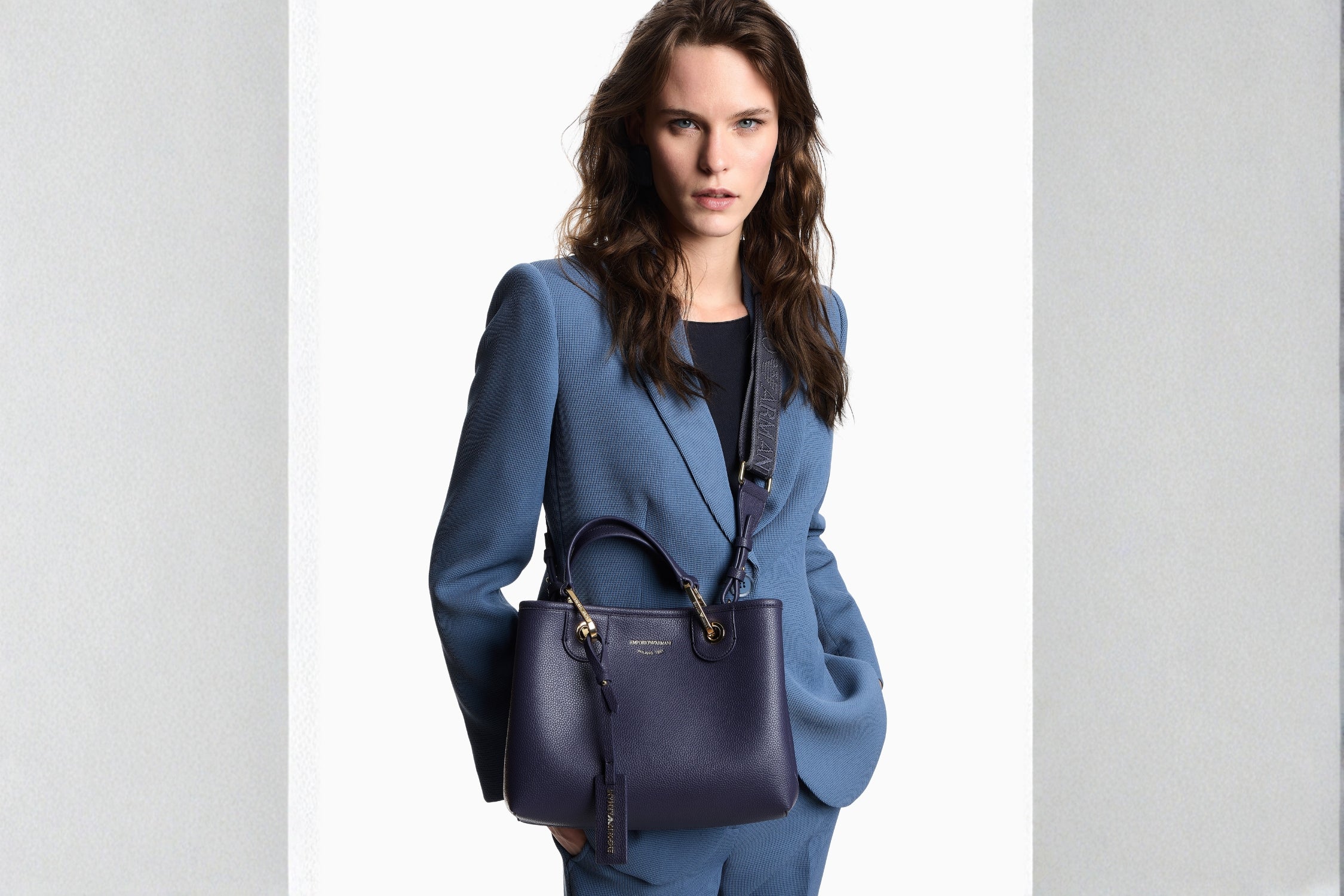 Emporio Armani Tote Bag paired with a tailored blue suit for a polished luxury look