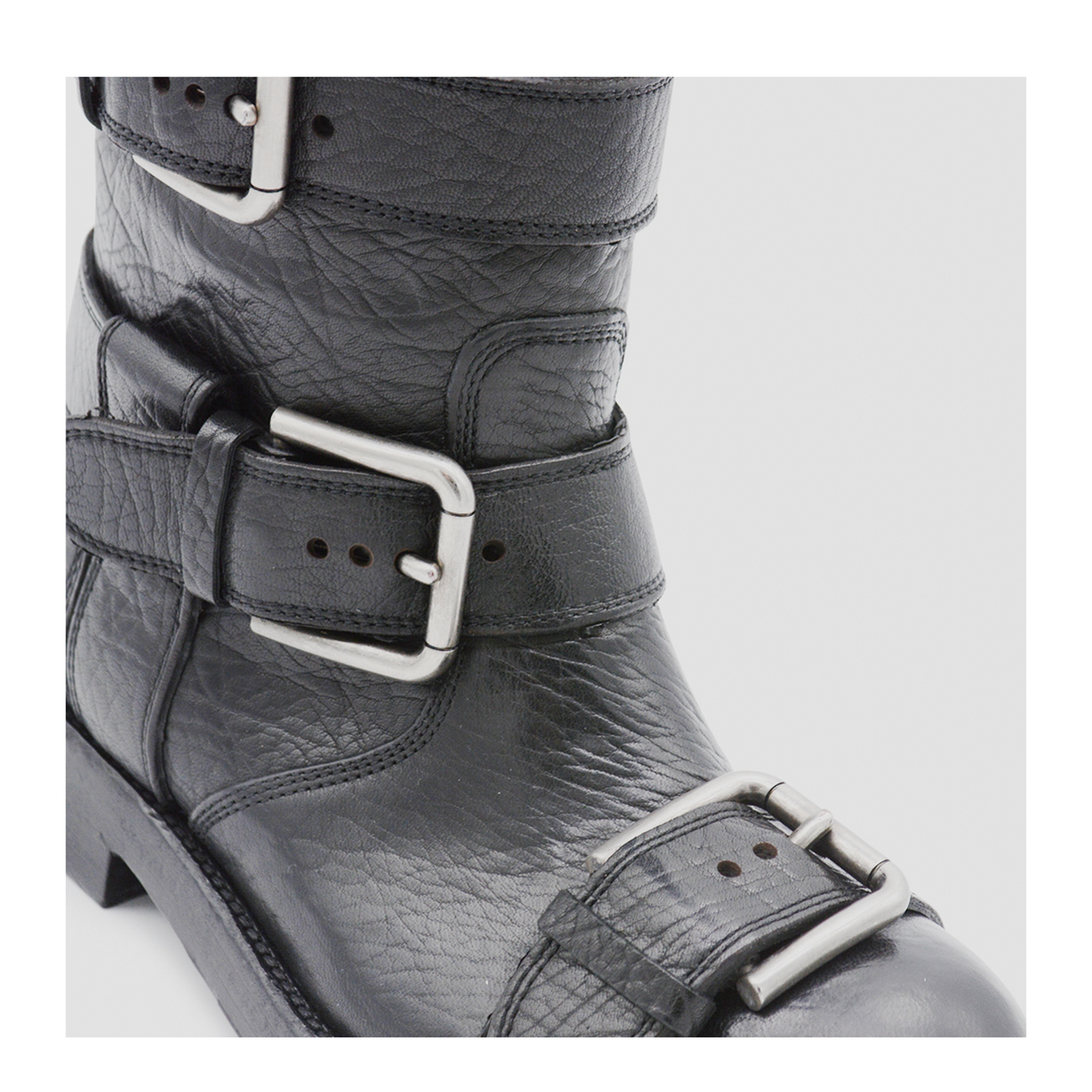 Black leather boots with straps
